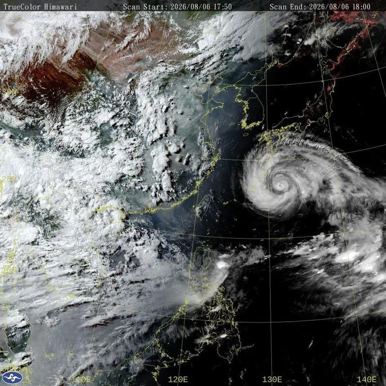 Satellite image from a weather satellite showing a powerful tropical cyclone with a clear eye and swirling clouds off Japan's east coast in the western Pacific.